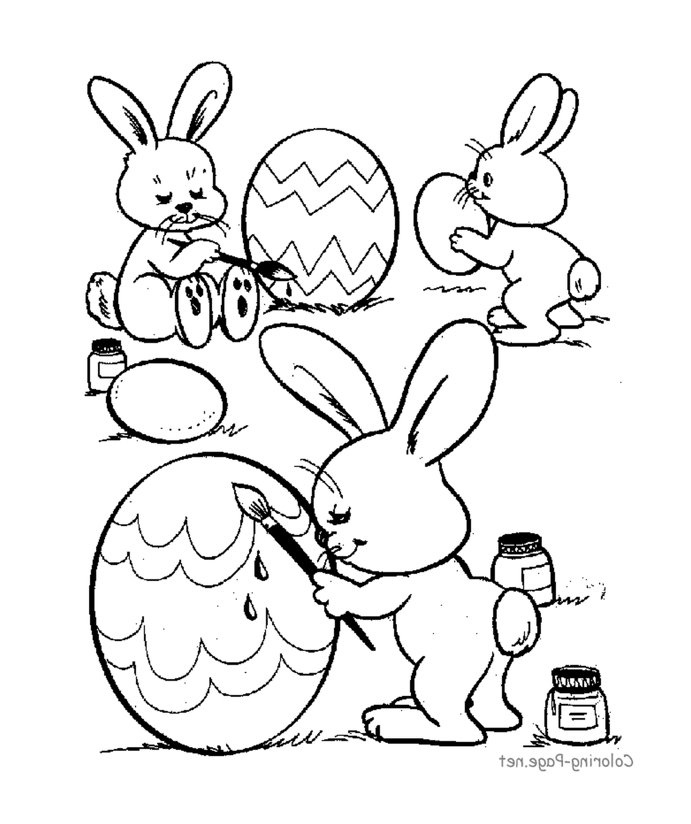   Un groupe de lapins peignant des œufs de Pâques 