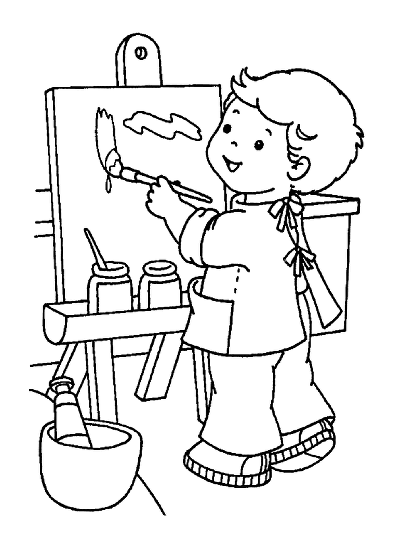   Un petit garçon qui peint à l'école 
