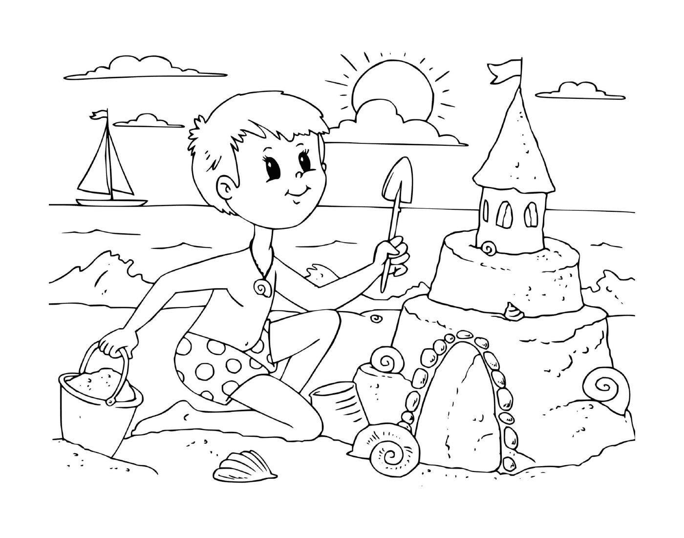   Un garçon construit un château de sable sur la plage 