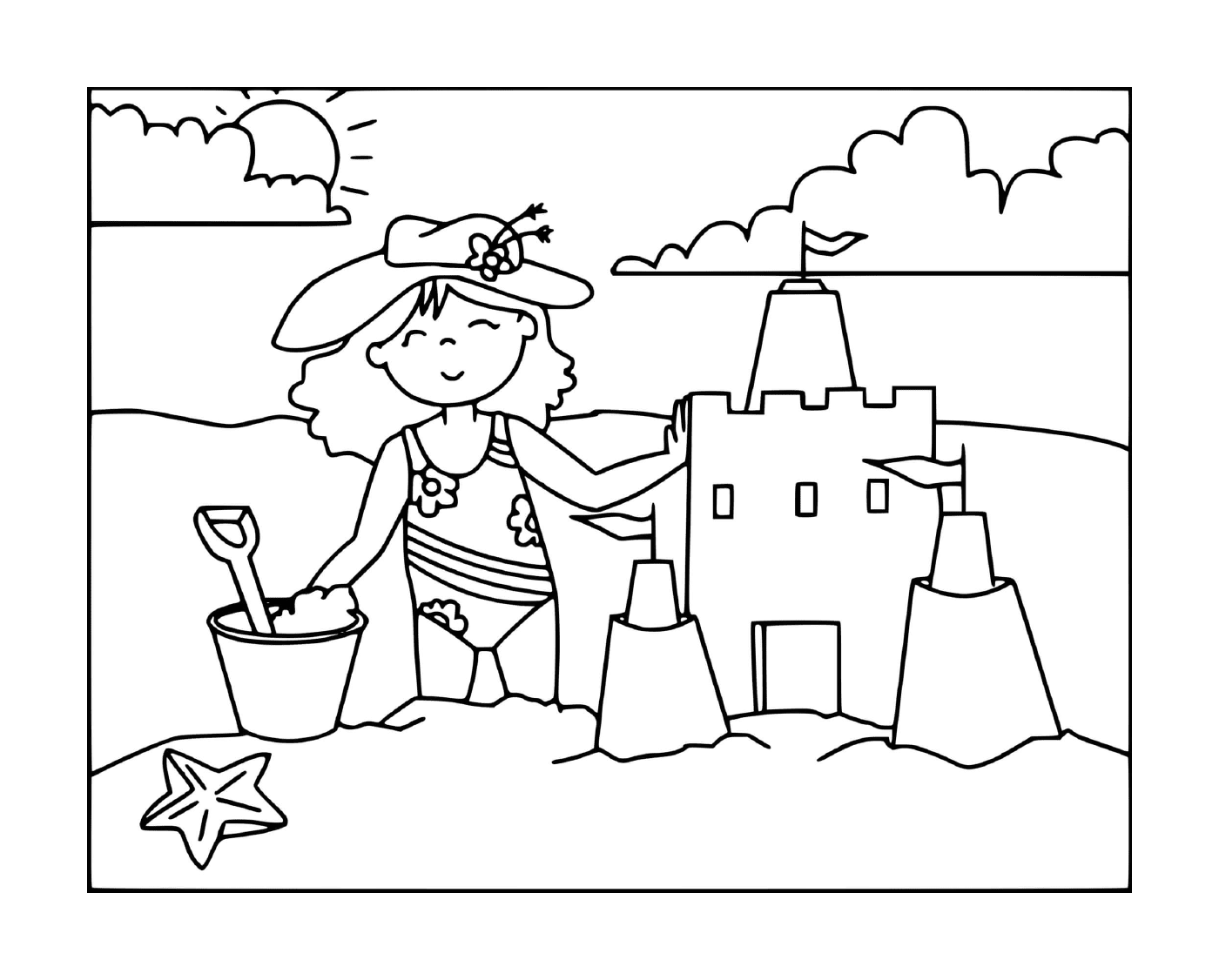   Une fille construit un château de sable sur la plage 