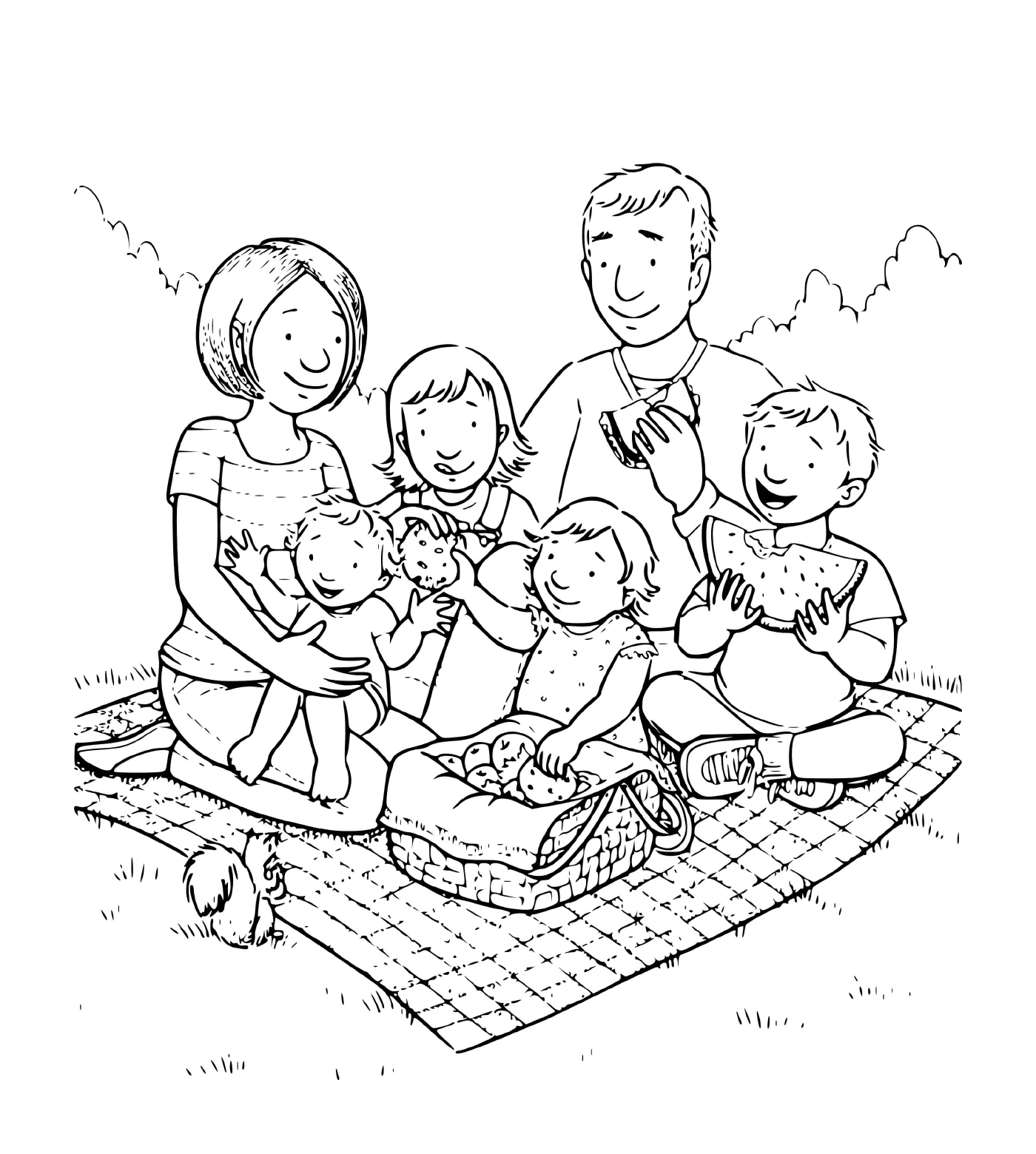   Une famille de quatre enfants faisant un pique-nique sur une couverture dans l'herbe 