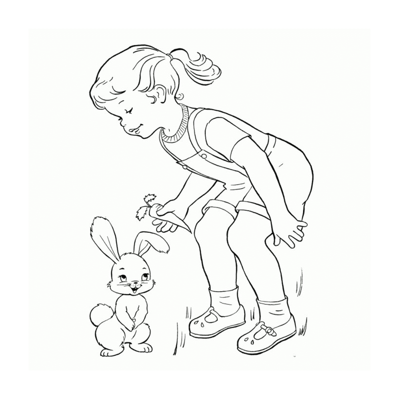   Une petite fille à côté d'un petit lapin 