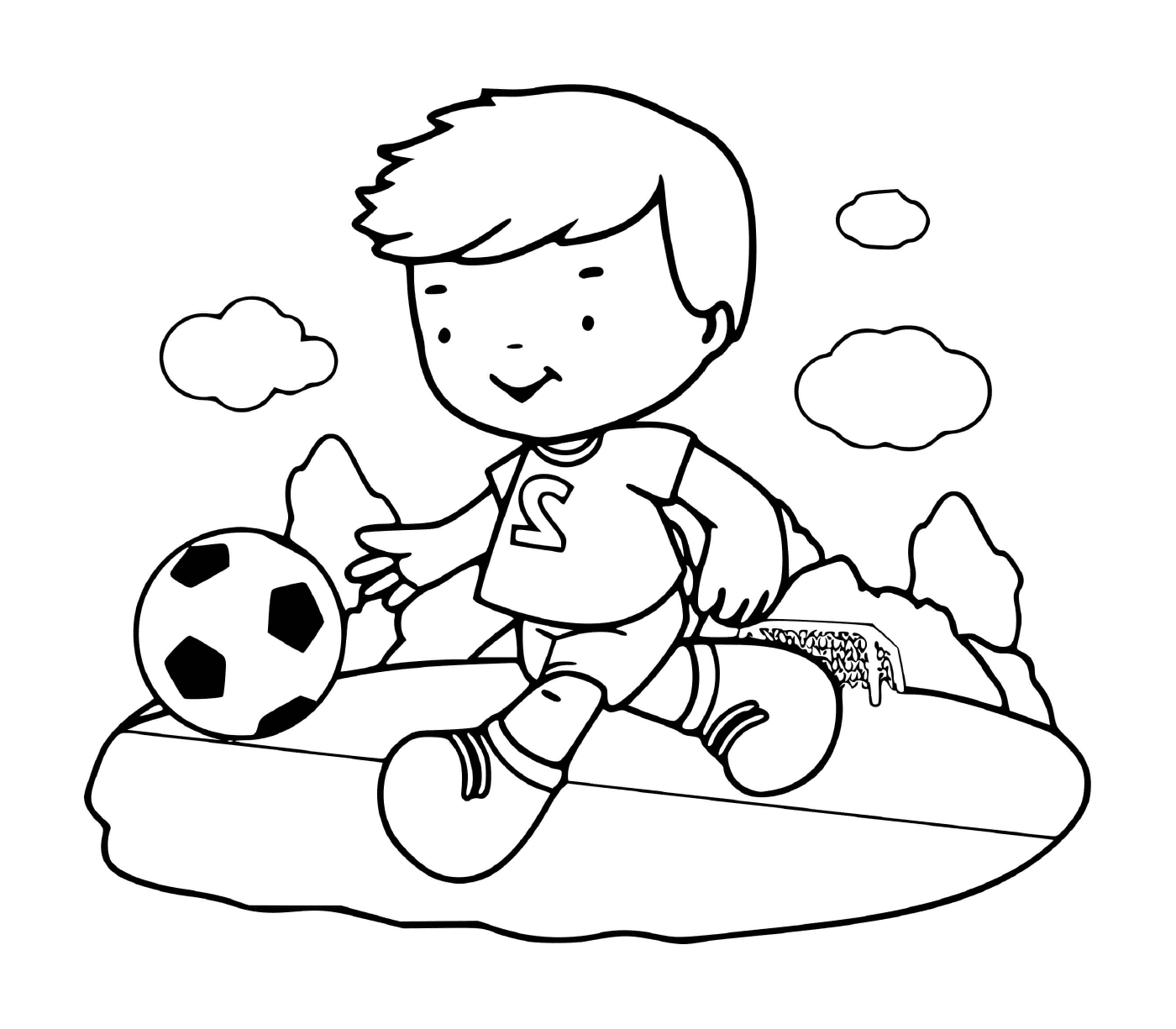   Un garçon joue avec enthousiasme au football 