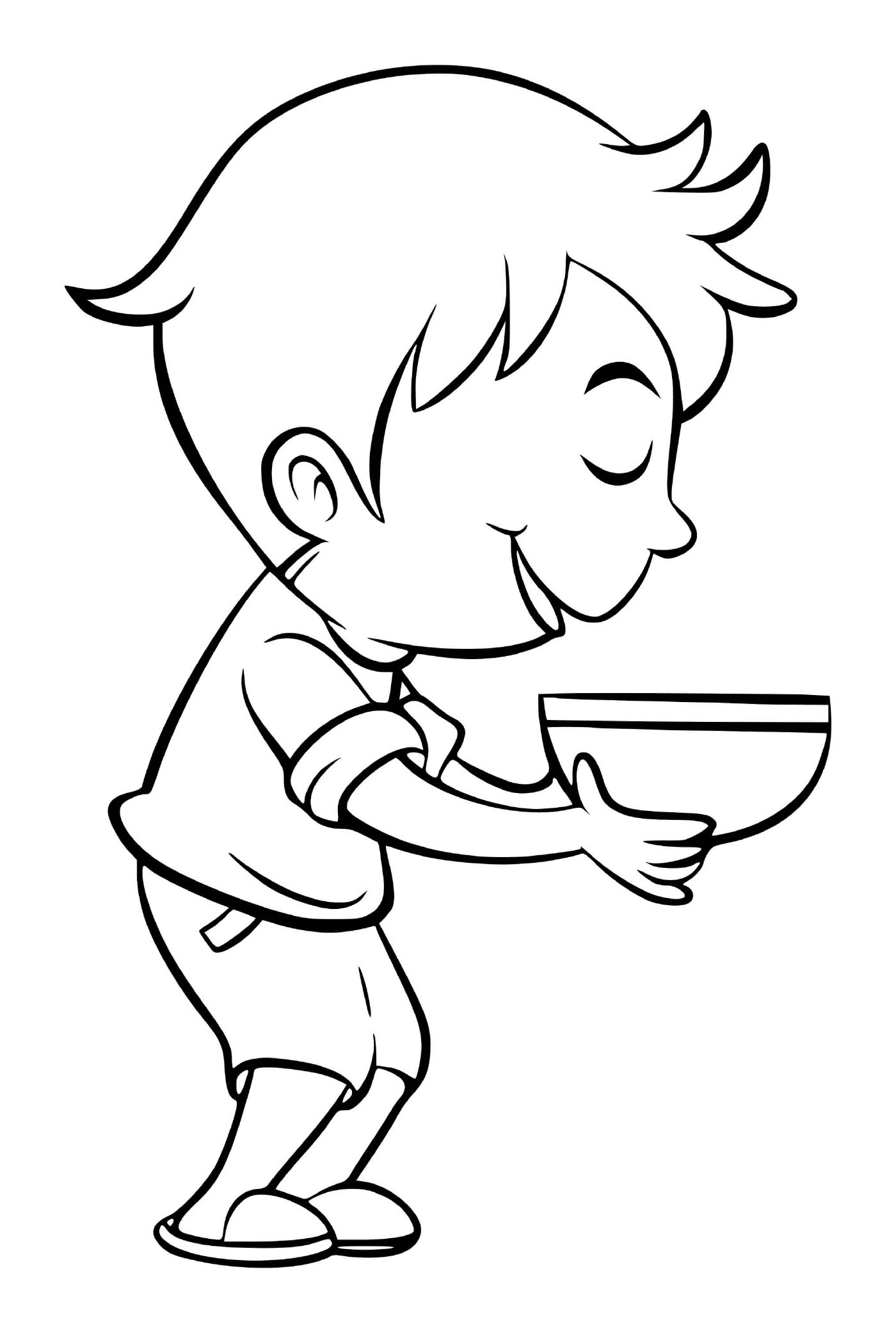   Un garçon mange une soupe au brocoli avec plaisir 