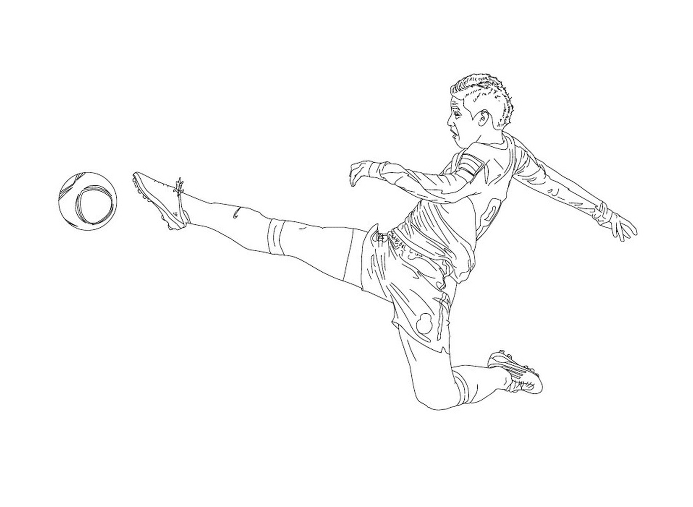  Un garçon donnant un coup de pied dans un ballon de football