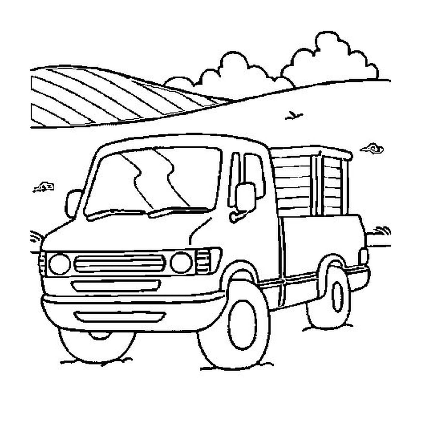   Un camion garé dans un champ près d'une colline 